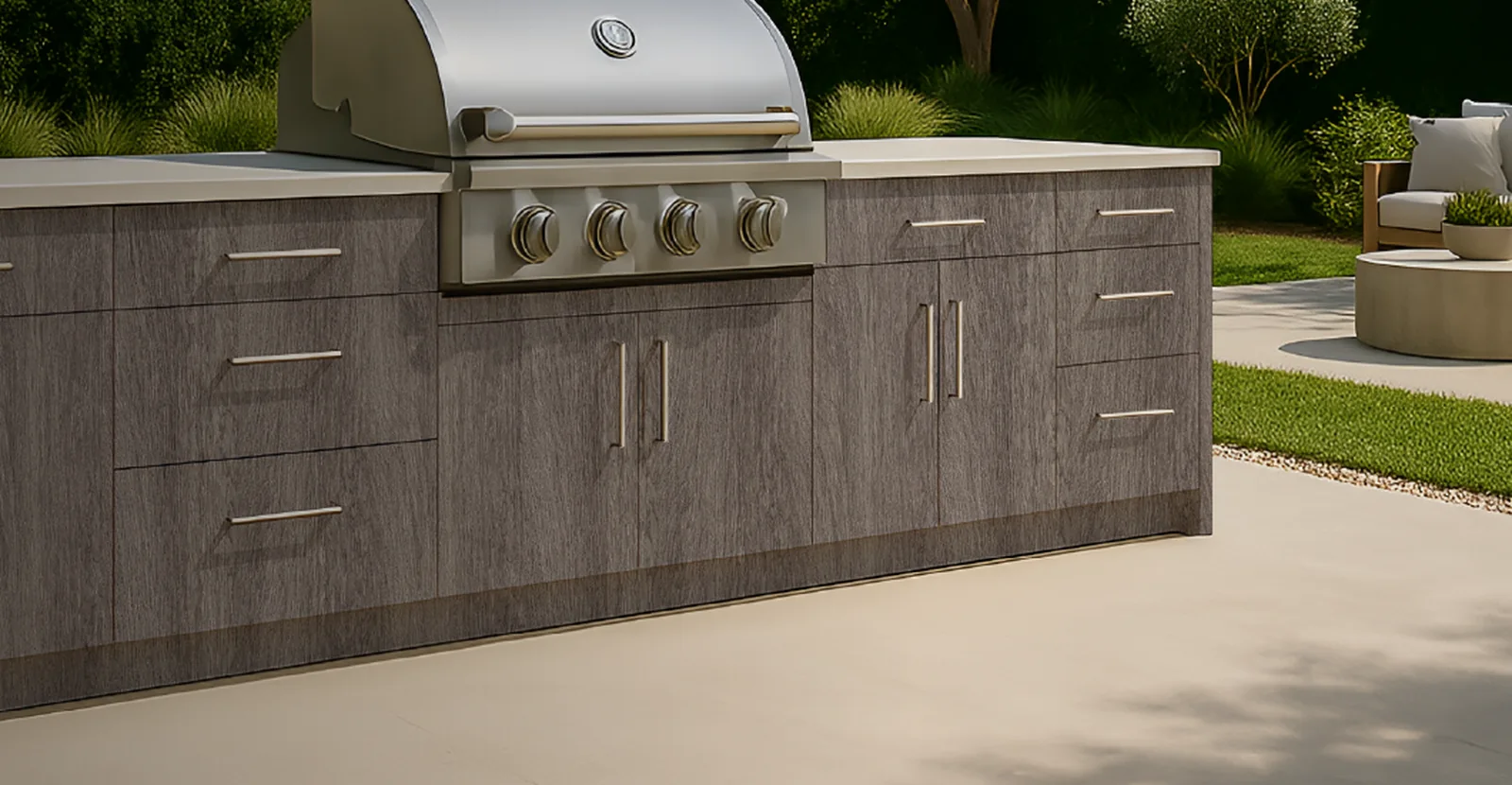 Outdoor kitchen cabinetry with integrated grill, slab doors, stainless pulls, and patio living space.